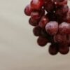 Vibrant red grapes on a vine, showcasing fresh and organic fruit perfect for healthy eating.
